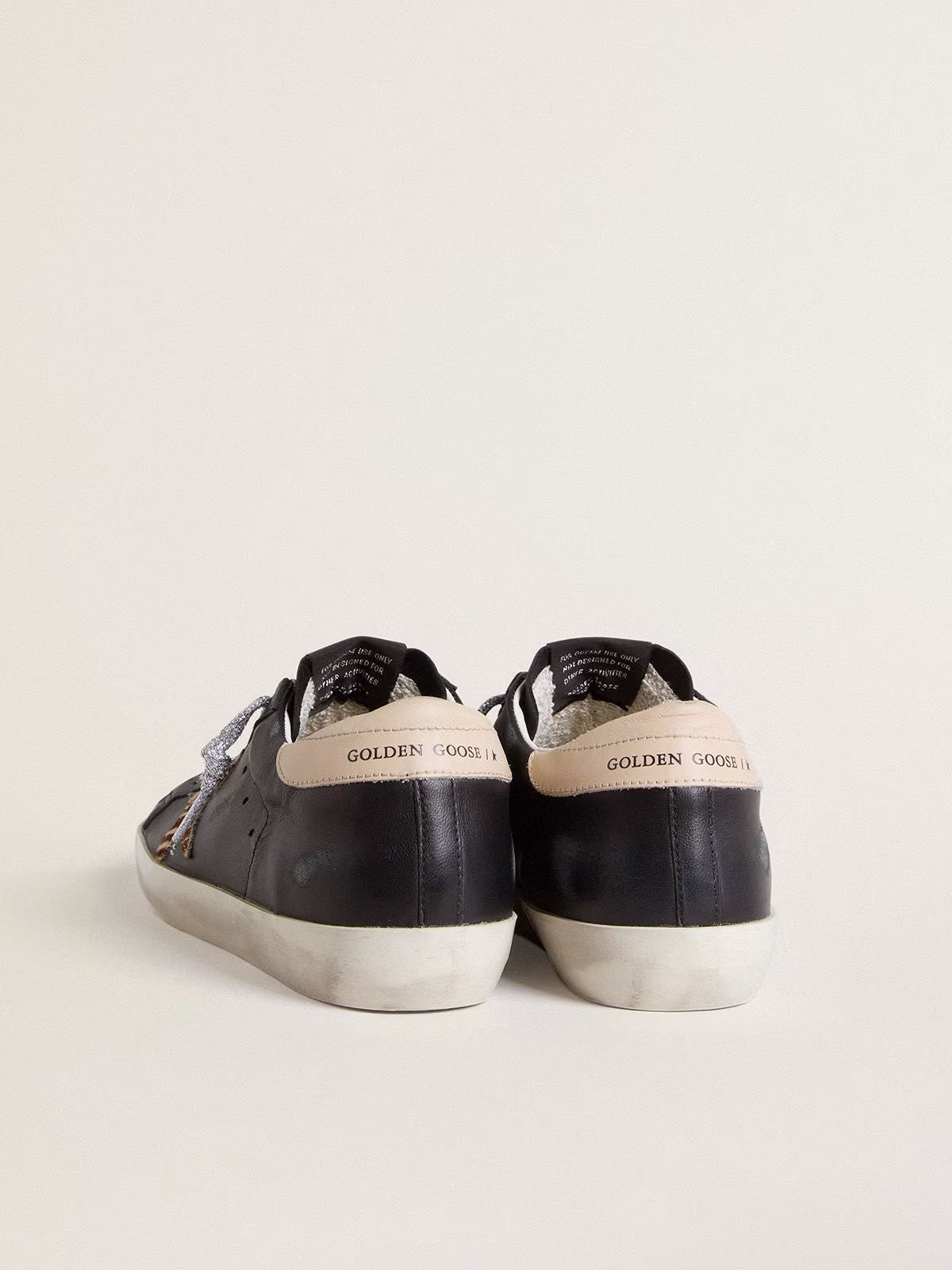 Nappa nera con stella in cavallino zebrato e talloncino in pelle beige
