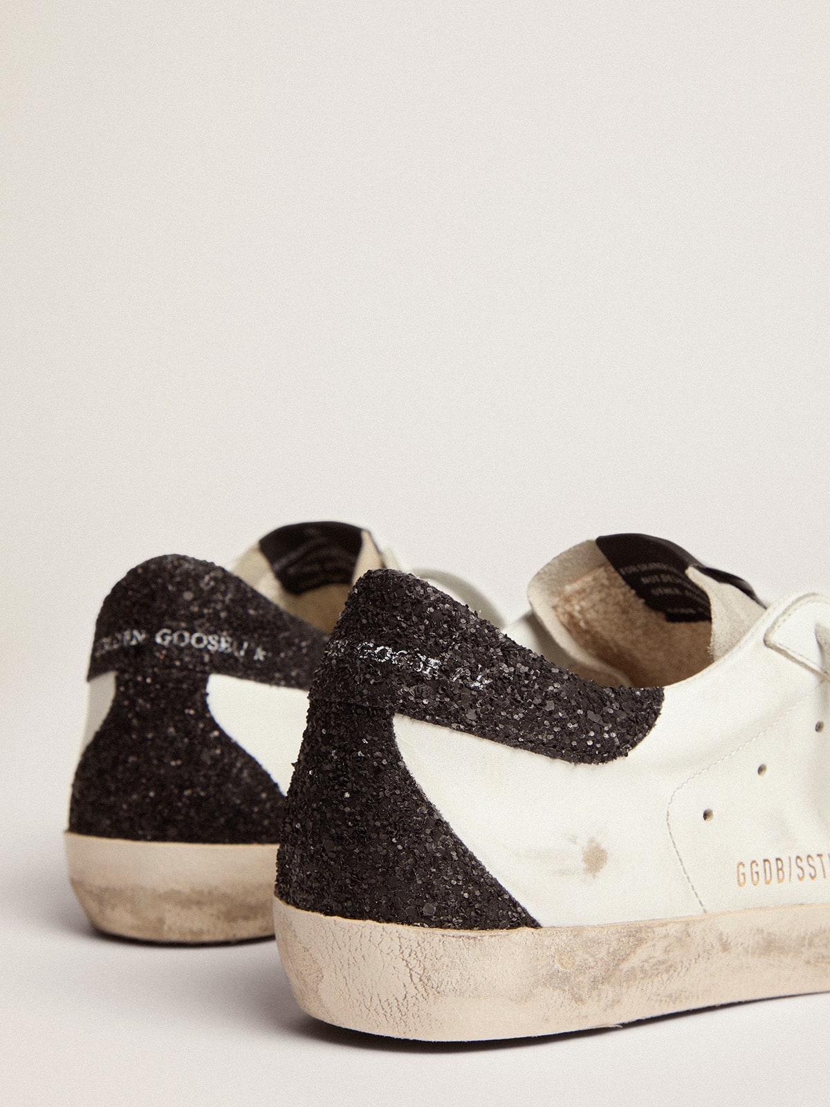 LTD con stella dorata e talloncino nero in glitter