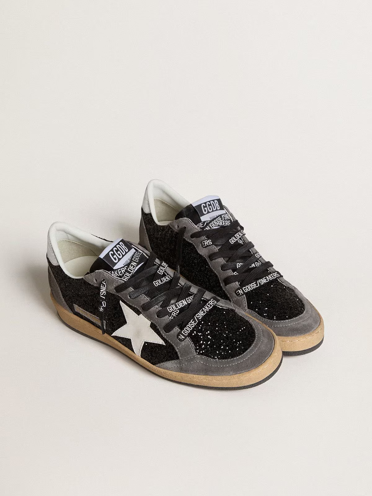 Glitter con stella in pelle e talloncino in pelle laminata