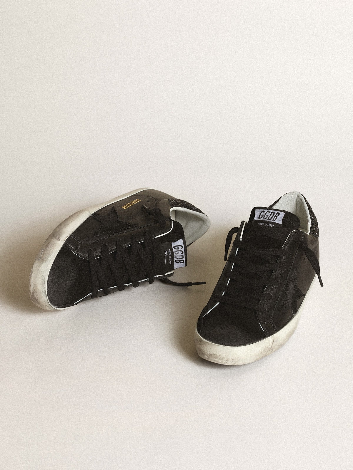 Nappa nera con stella in suede nero e talloncino in glitter neri